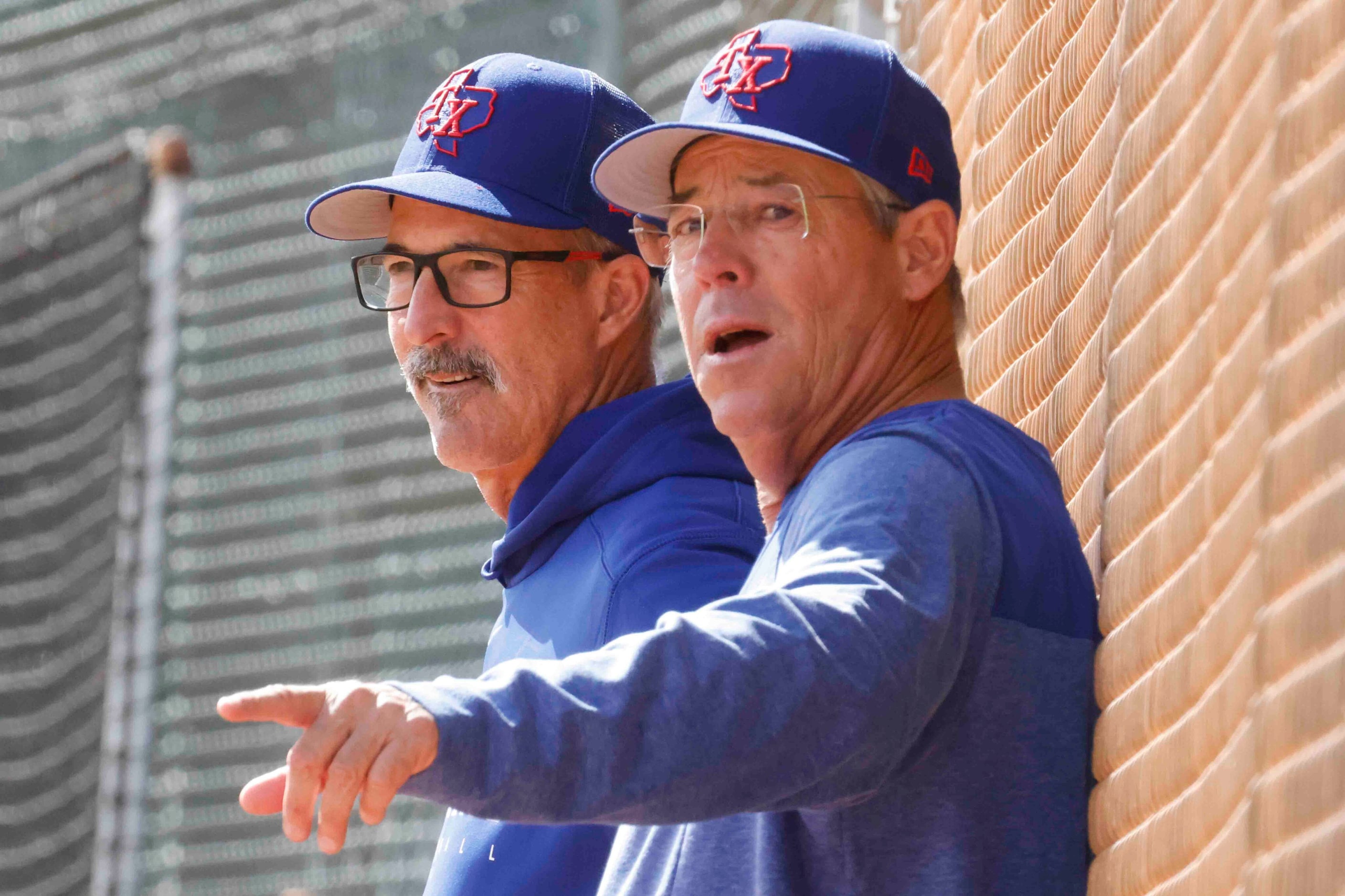 Texas Rangers pitching coach Mike Maddux, left, and special assistant Greg Maddux watch...