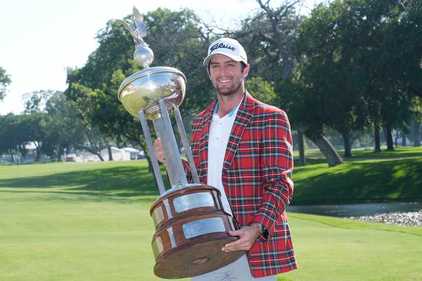 Davis Riley poses with the winner's trophy at the Charles Schwab Challenge golf tournament...