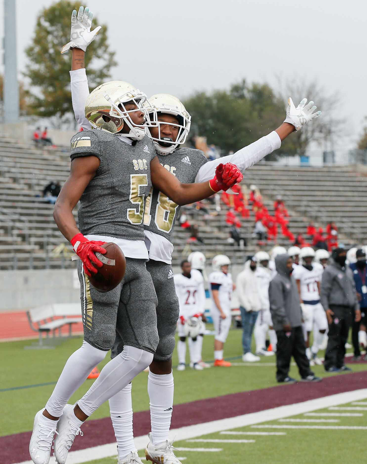 South Oak Cliff sophomore wide receiver Randy Reece (5) is congratulated by junior wide...