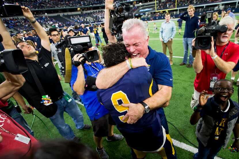 Highland Park quarterback John Stephen Jones (9) gets a hug from his father, Dallas Cowboys...
