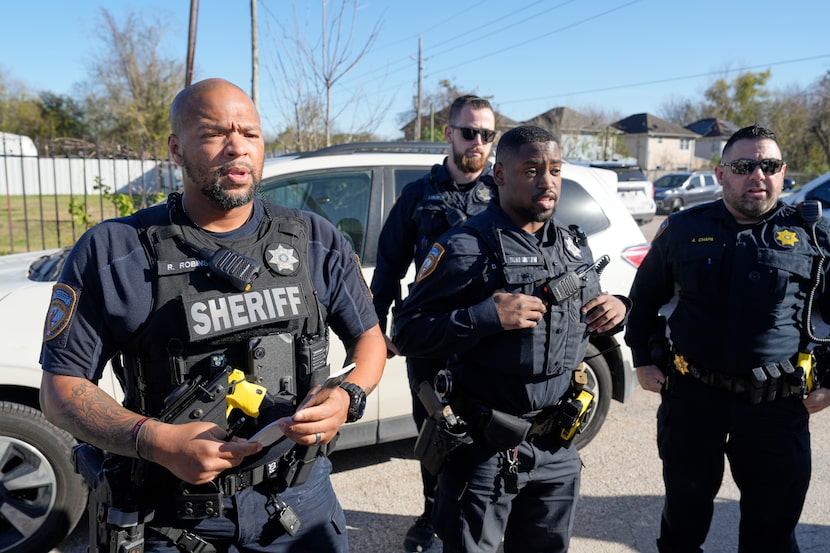 Harris County Sheriff's officers clear the media from the neighborhood in Houston where...