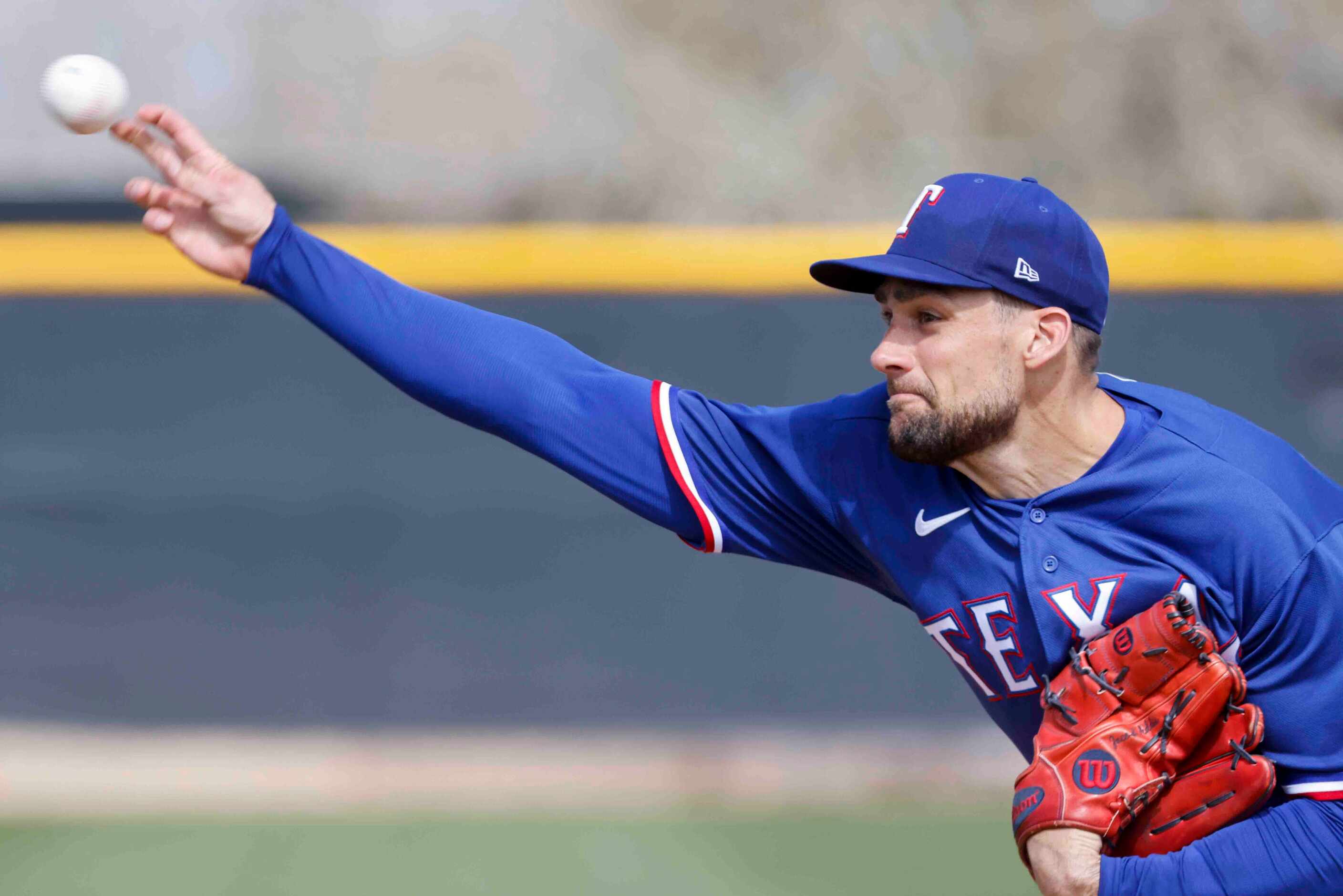 Texas Rangers pitcher Nathan Eovaldi pitches during a spring training workout at the team's...