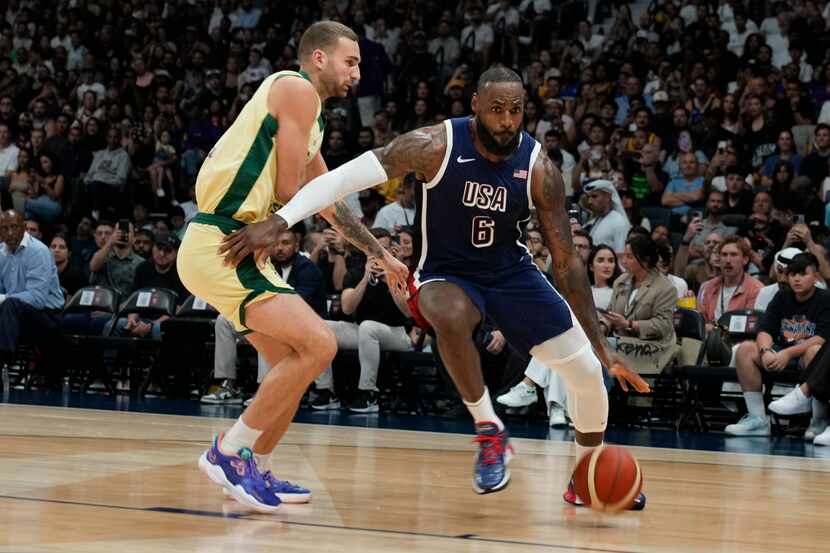 Team USA's LeBron James, right, drives past against Australia's Jack McVeigh during the USA...