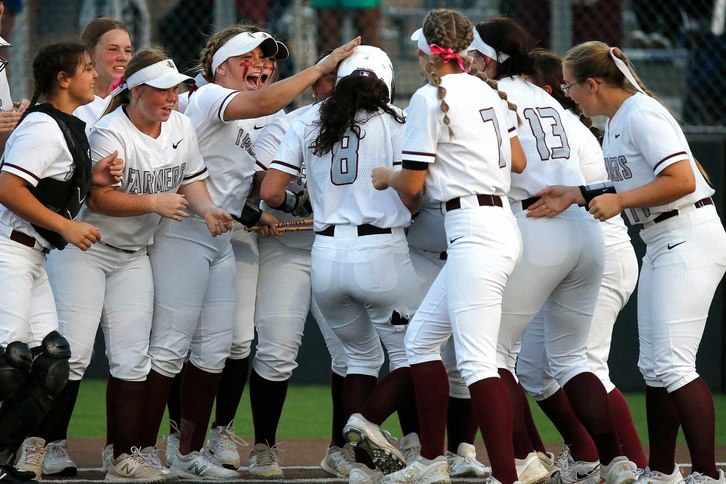 Lewisville High School left fielder Rylee Brice (8) is met at home plate after hitting a...