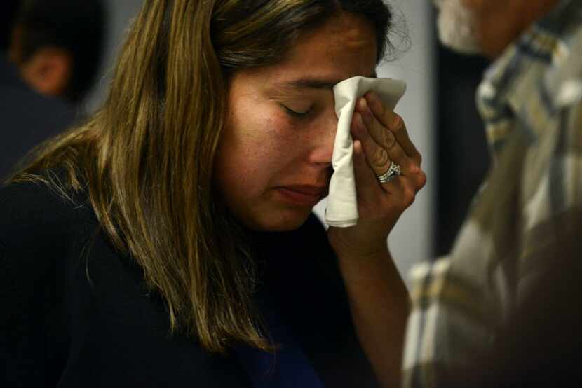  Carmen Osowski of Brownsville, Texas, wipes tears from her face after the process of...