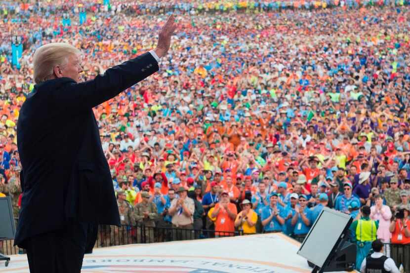 President Donald Trump waves after speaking to Boy Scouts during the National Boy Scout...