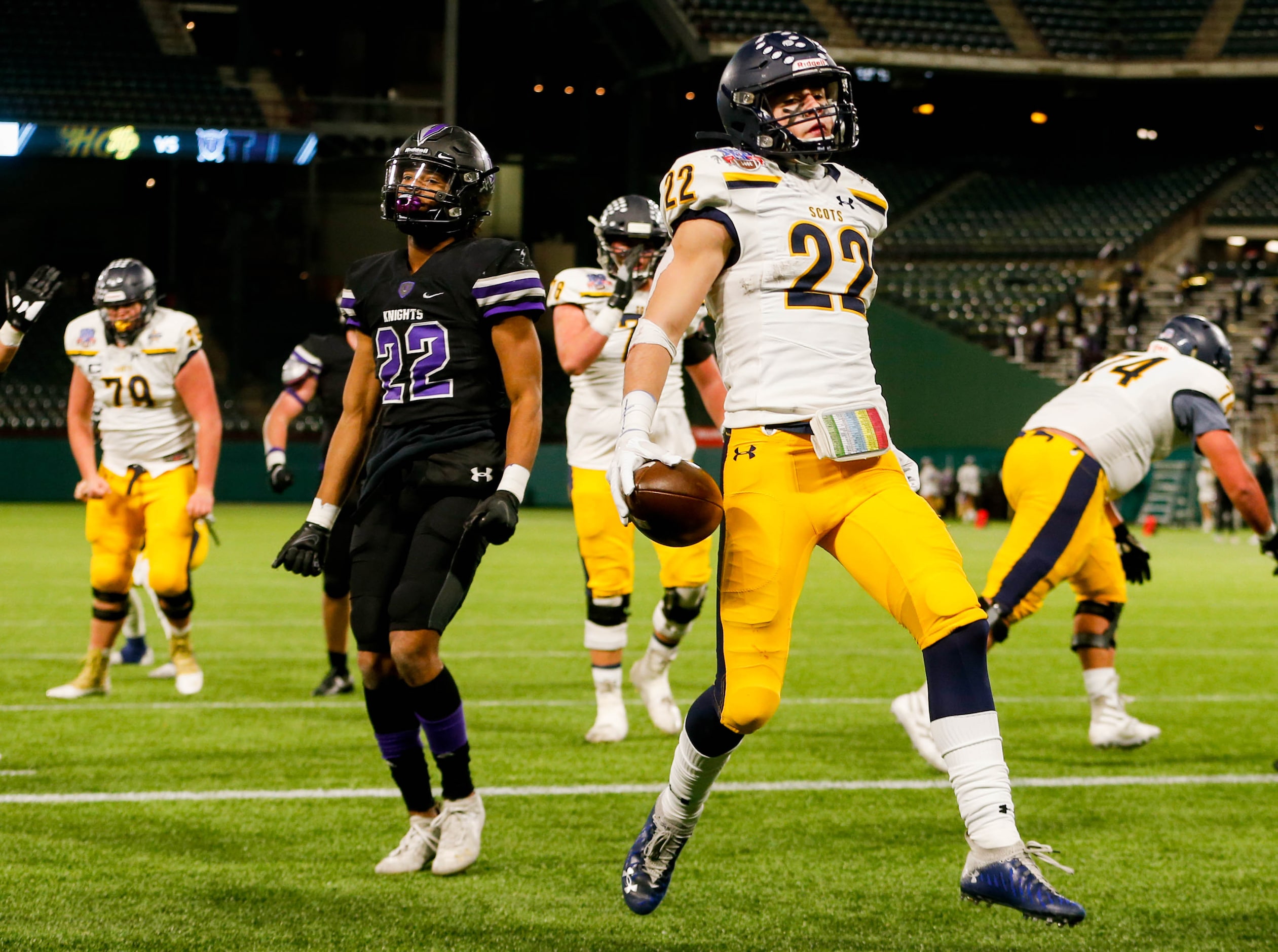 Highland Park's Brooks Bond (22) runs past Frisco Independence's Brayden West (22) for a...