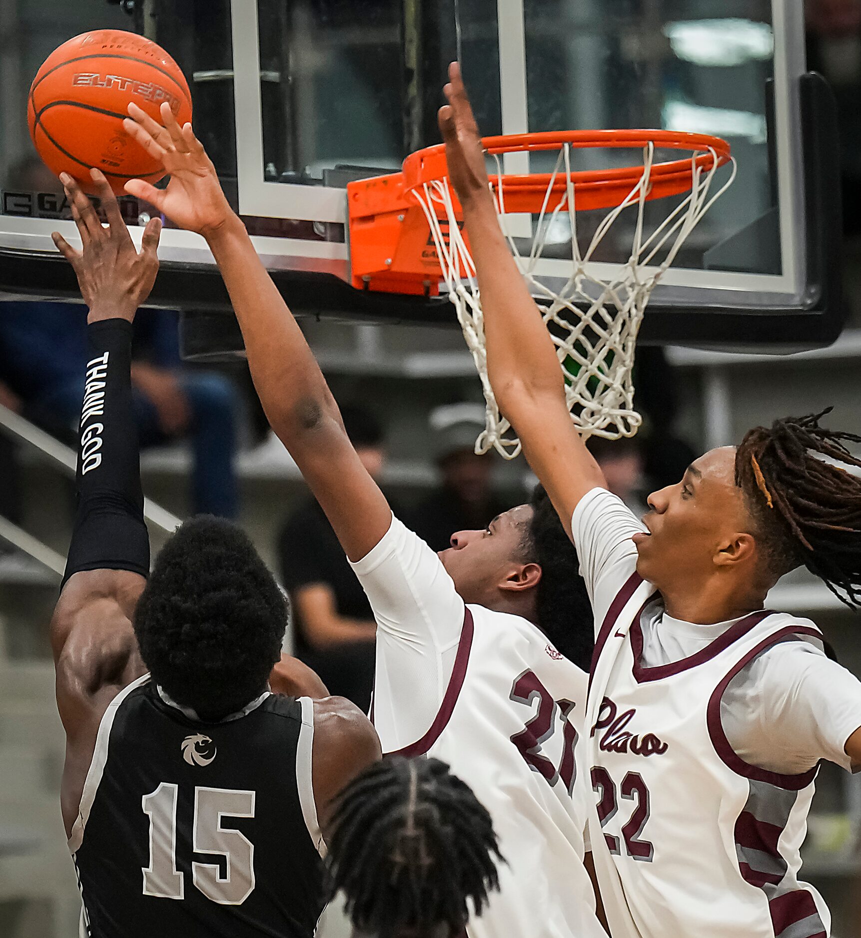 Plano forward Justin McBride (21) blocks a shot by Denton Guyer forward Akintola Akinniyi...