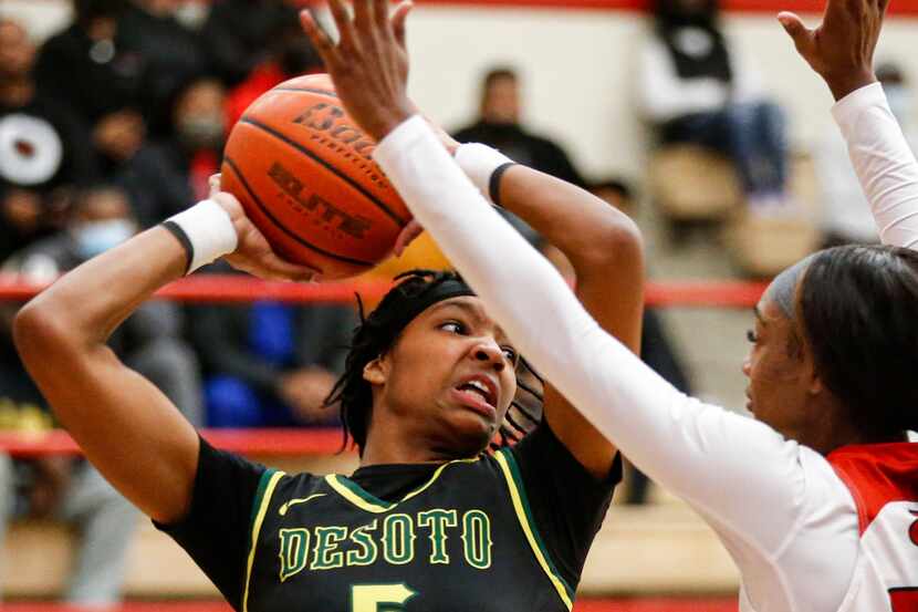 DeSoto High School Sa'Myah Smith (5) keeps the ball away from Cedar Hill High School Janyia...
