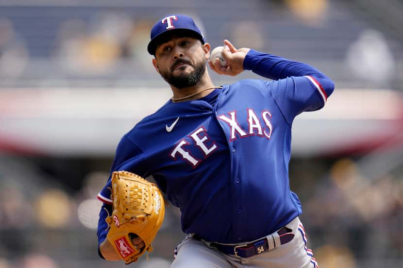 Texas Rangers starting pitcher Martin Perez delivers during the first inning of a baseball...