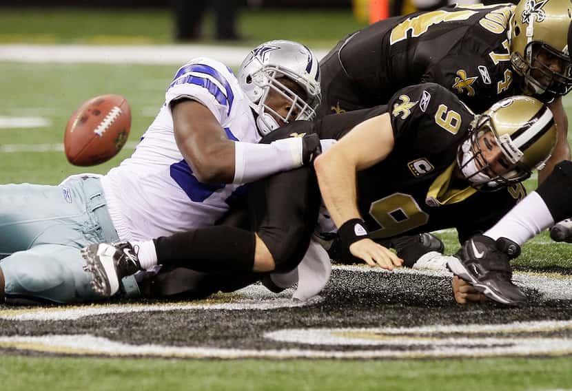 New Orleans Saints quarterback Drew Brees fumbles in the closing seconds under pressure from...