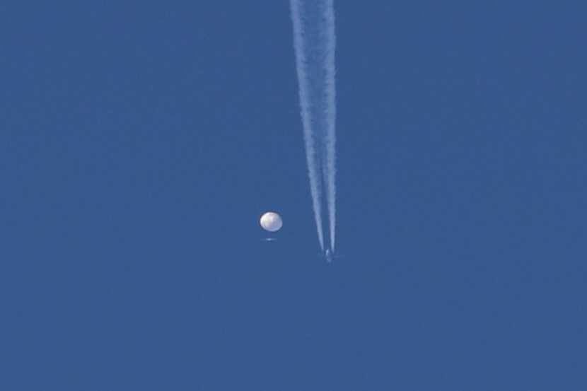 In this photo provided by Brian Branch, a large balloon drifts above the Kingstown, N.C....