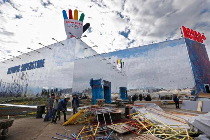 
FILE - In this Wednesday, Feb. 5, 2014 file photo, construction workers move scaffolding as...