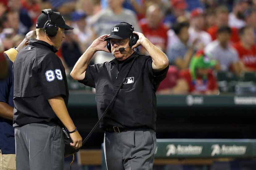 Umpire crew cheif Jim Joyce donned the headset hear discuss a replay of Philadelphia...