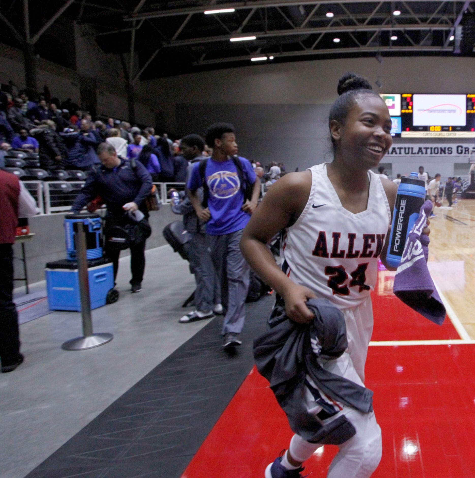 Allen senior guard Cydni Adams (24) was all smiles as she hurries to join her teammates for...