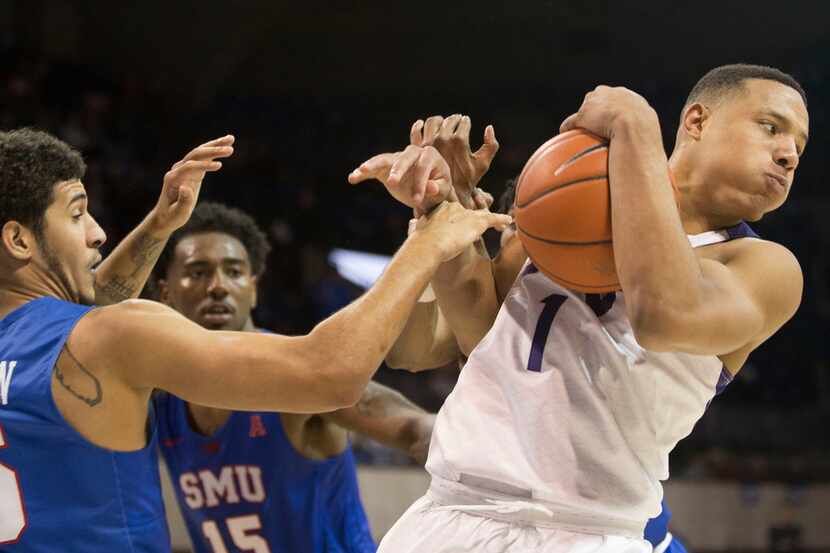 FILE - TCU guard Desmond Bane (1) maintains the ball from the SMU defense during a matchup...