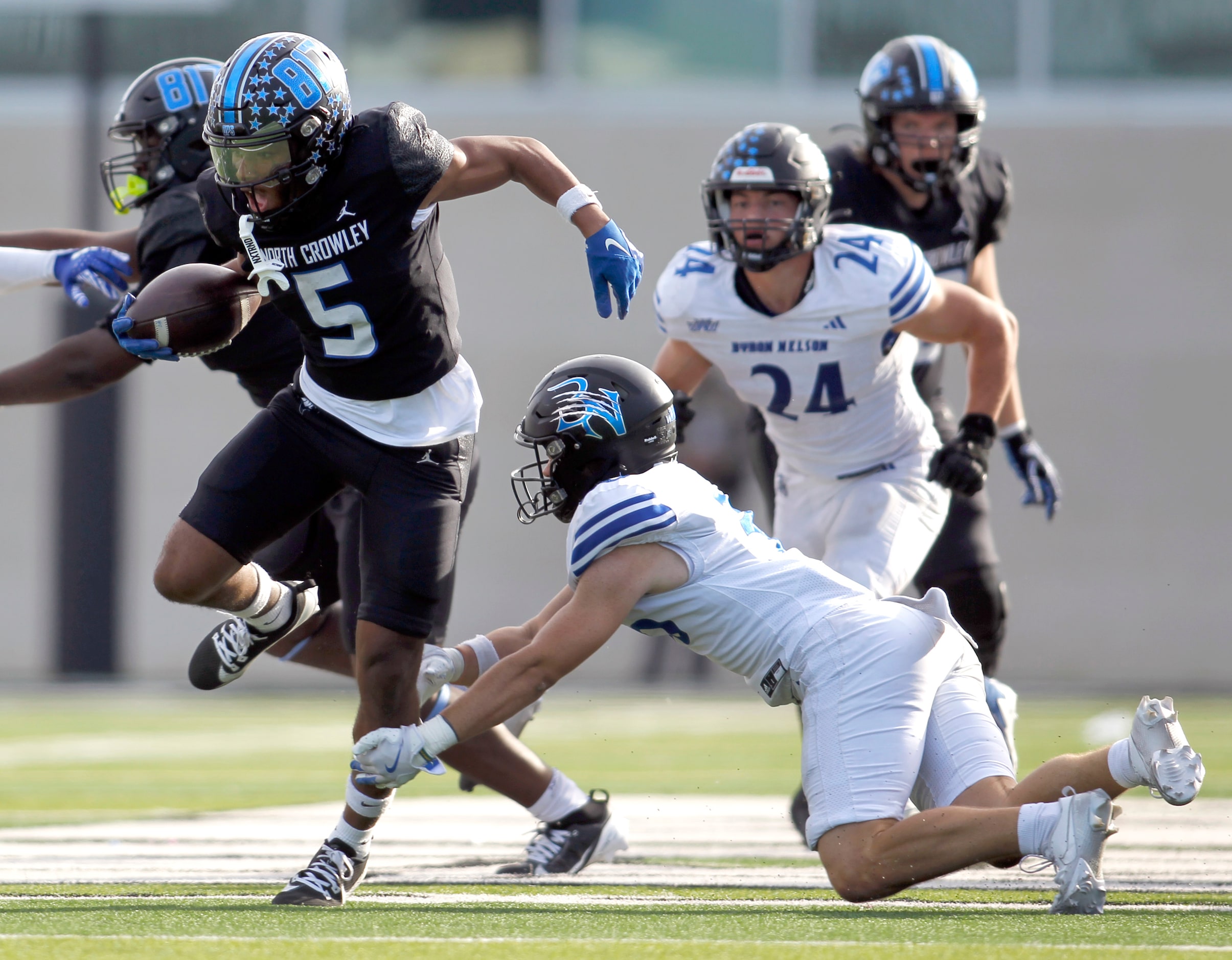 North Crowley running back Daniel Bray (5), left, is unable to elude the tackle of Byron...