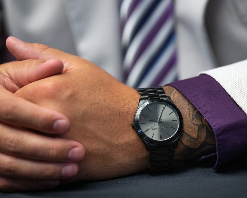 Trey Dishon, defensive tackle for Kansas State University, wears a Michael Kors watch during...