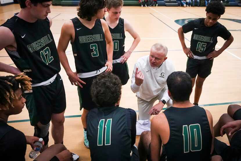 Greenhill head coach Joey Sims huddles with his team during a timeout in a SPC high school...