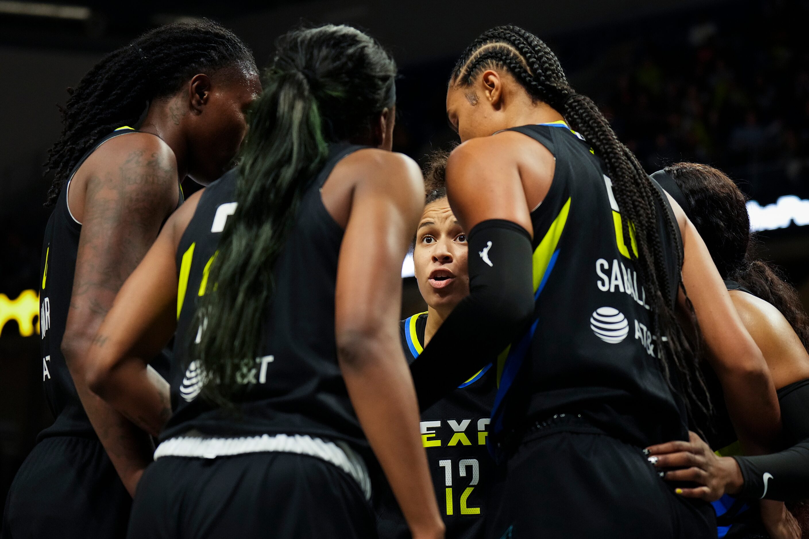 Dallas Wings guard Veronica Burton (12) huddles with teammates during the second half of a...