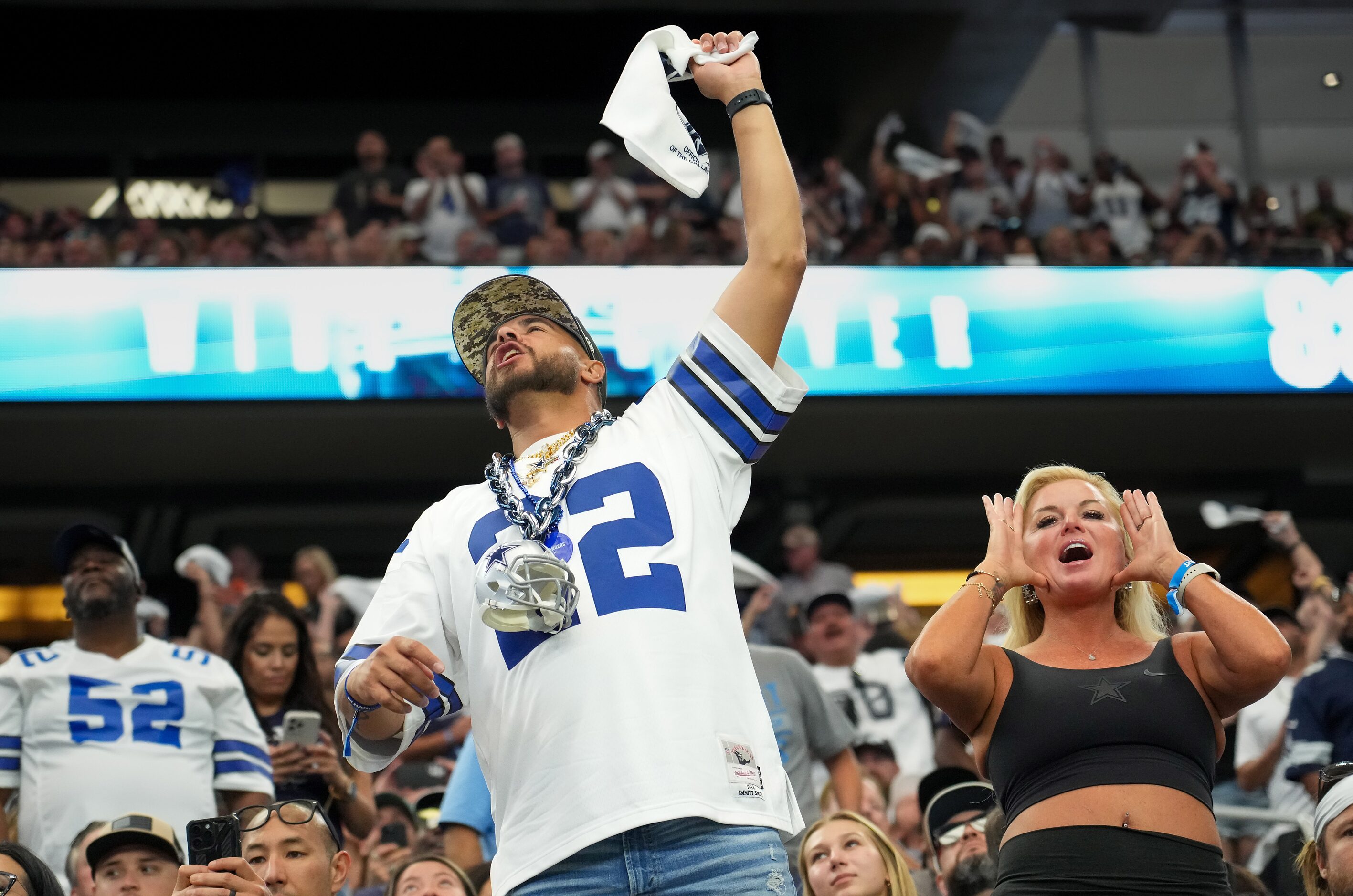 Dallas Cowboys fans cheer their team during the first half of an NFL football game against...