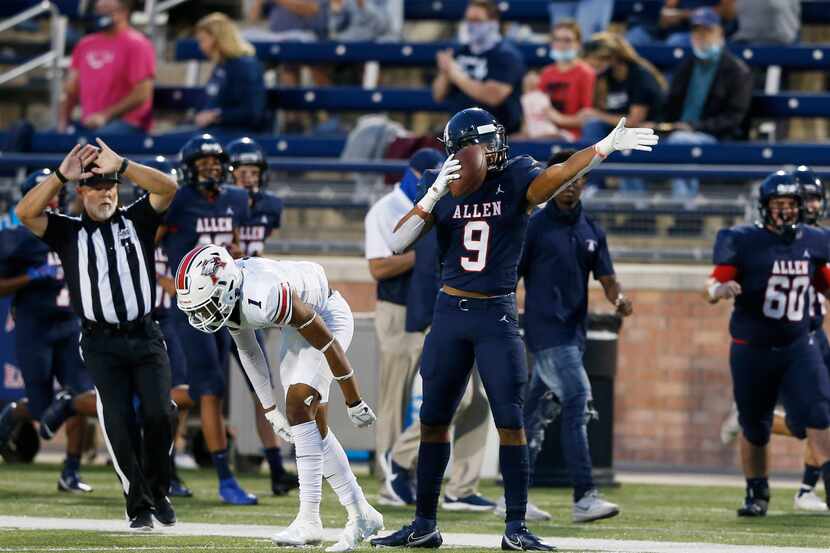 Allen's Bryson Green (9) signals the first down after making a catch in front of Humble...