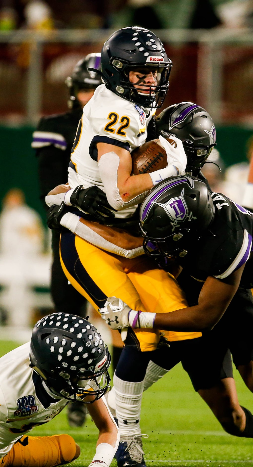 Highland Park's Brooks Bond (22) is tackled by the Frisco Independence defense during the...