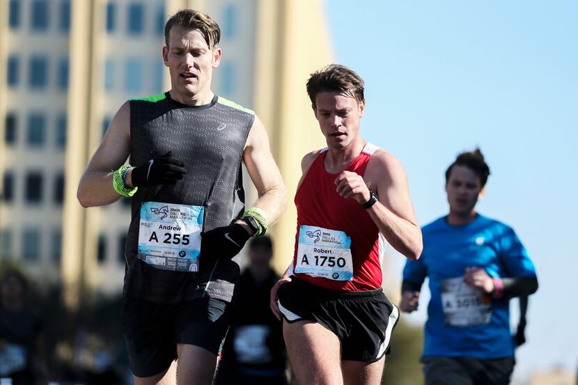Runners approach the finish line during the BMW Dallas Marathon at Dallas City Hall Plaza in...