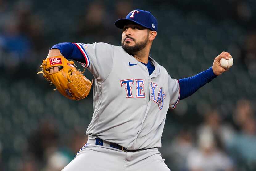 FILE - Texas Rangers starting pitcher Martin Perez throws against the Seattle Mariners...