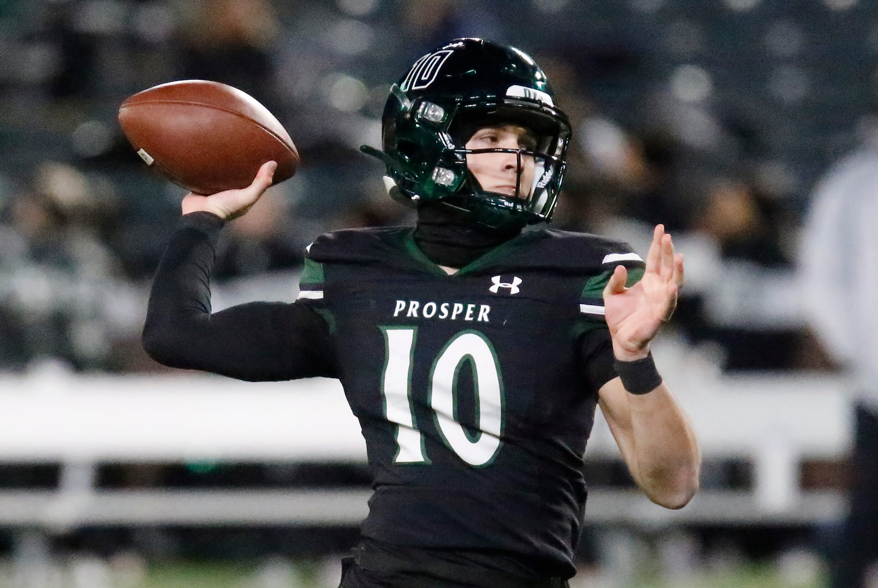 Prosper High School quarterback Harrison Rosar (10) throws a touchdown pass during the first...