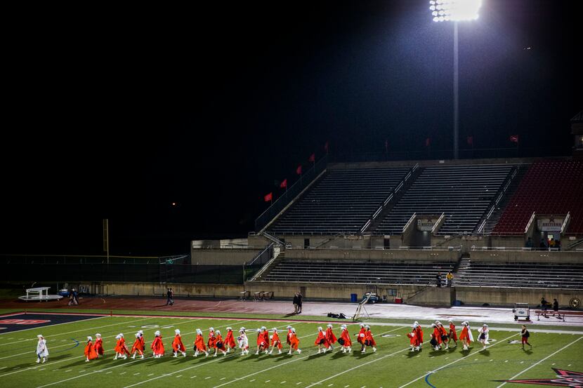 The Coppell dance team evacuates the stadium for a lightning delay just before the third...