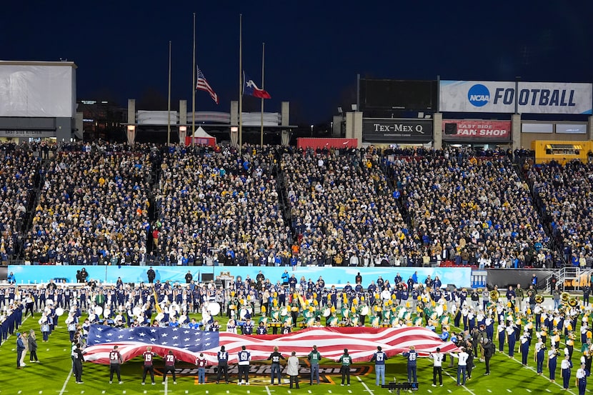 A United States and a Texas flag are seen at half mast in honor of former President Jimmy...