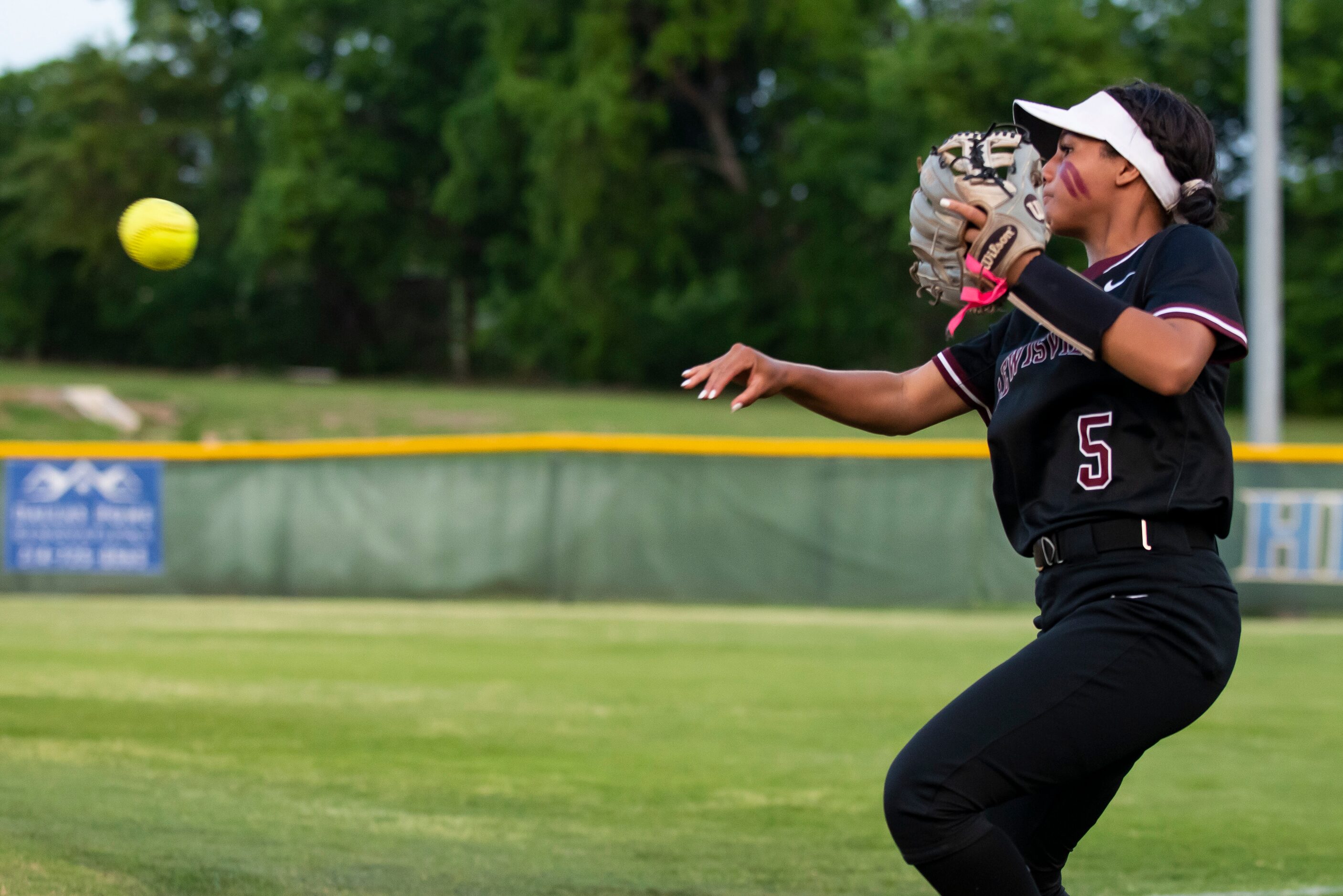 Lewisville’s Jadyn Grandison (5) throws the ball to first base in an attempt to get the...