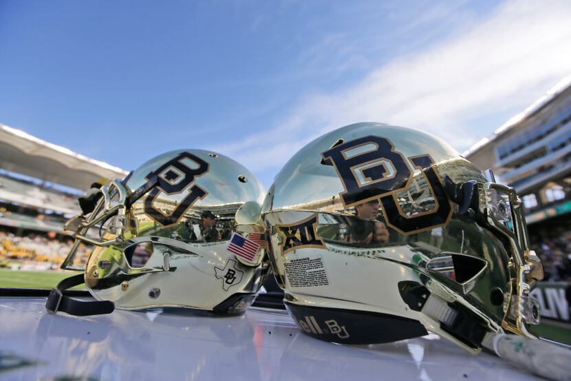 In this Dec. 5, 2015, file photo, Baylor helmets on shown the field after an NCAA college...