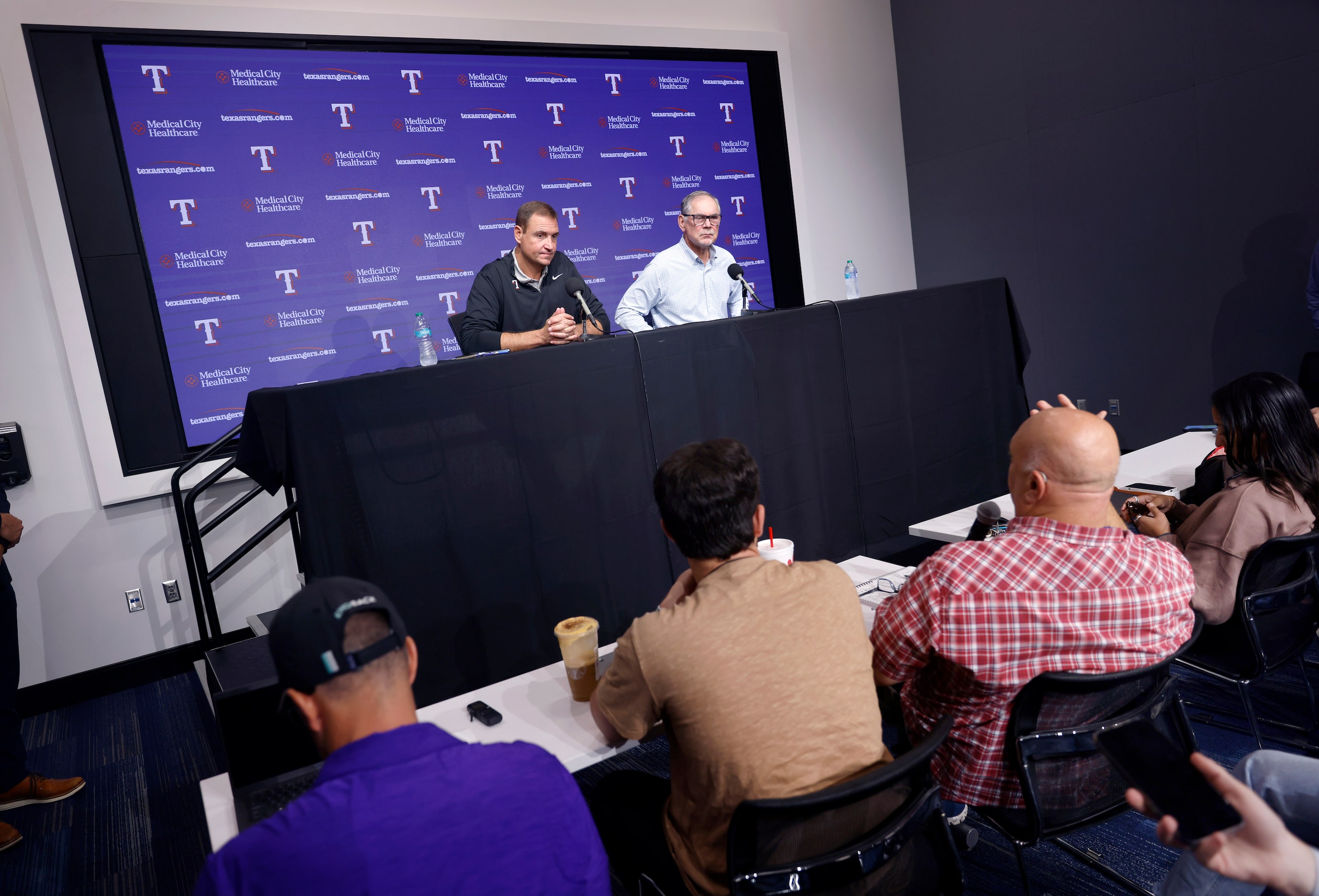 Texas Rangers general manager Chris Young (left) and manager Bruce Bochy respond to...