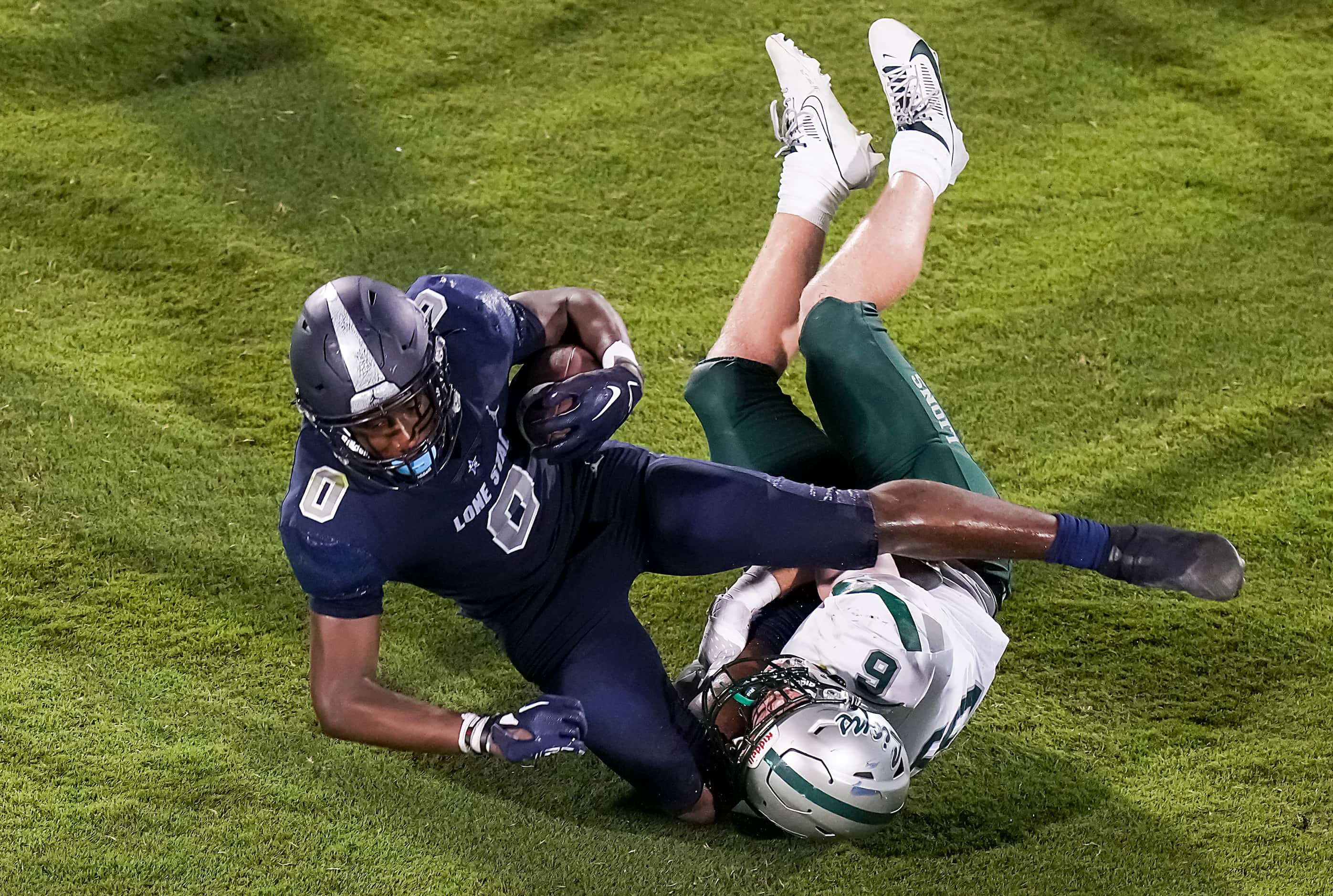 Frisco Lone Star’s  Davian Groce is brought down by Frisco Reedy’s Cade Hebel (6) during the...
