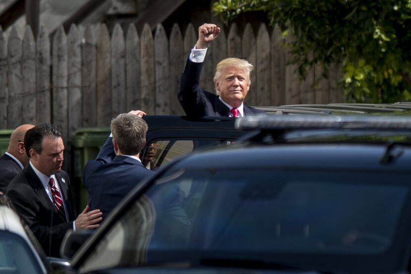 Donald Trump leaves a meeting with House Republicans at the Capitol Hill Club in Washington...