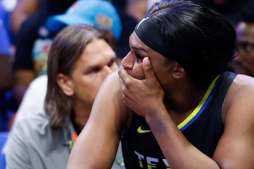 Dallas Wings center Teaira McCowan remains on the bench after being subbed during the second...