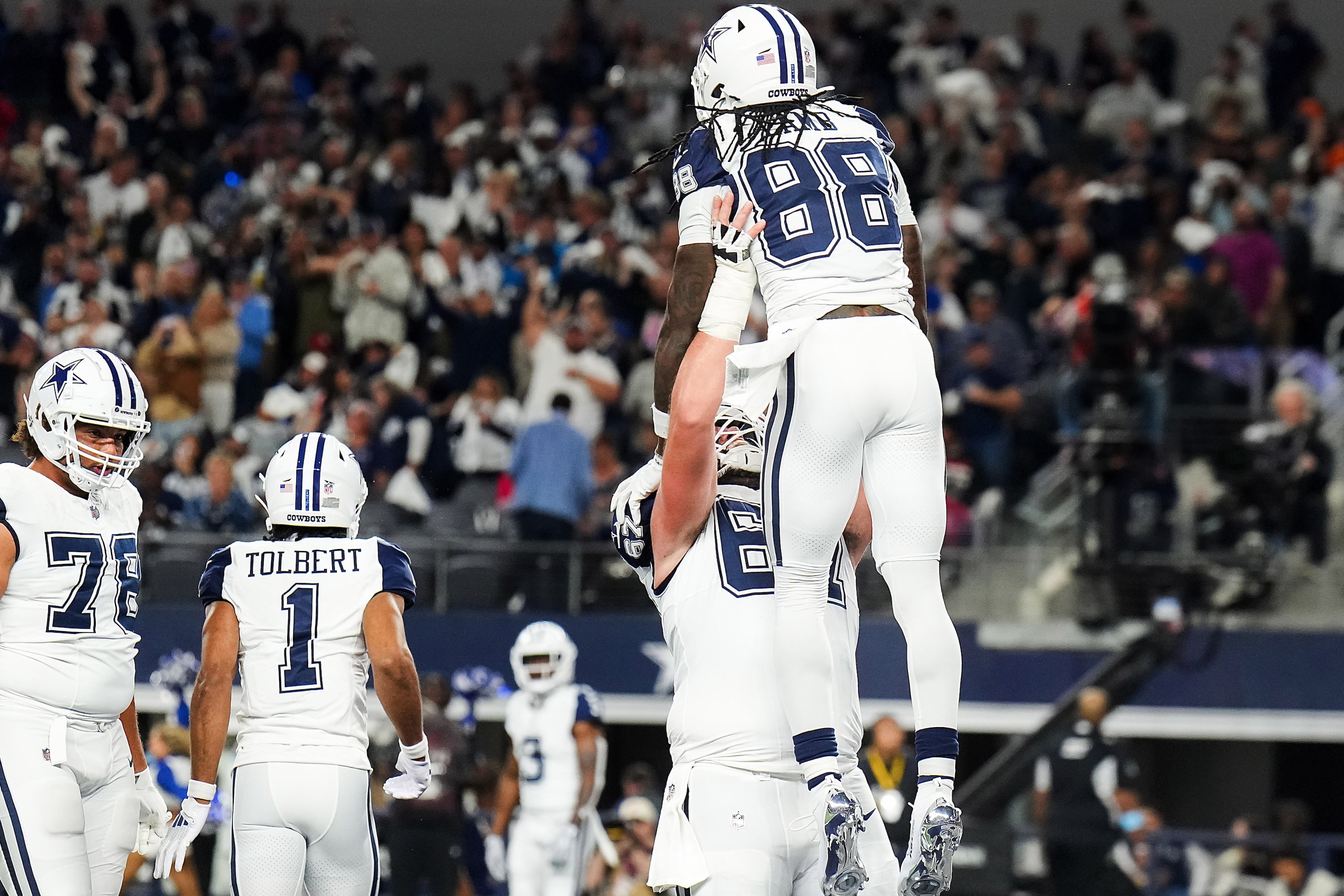 Dallas Cowboys wide receiver CeeDee Lamb (88) celebrates a touchdown reception with center...