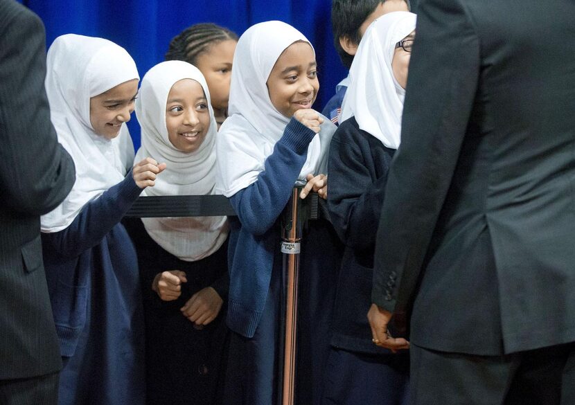 Girls lined up  to “fist bump” President Barack Obama, who stopped to greet schoolchildren...