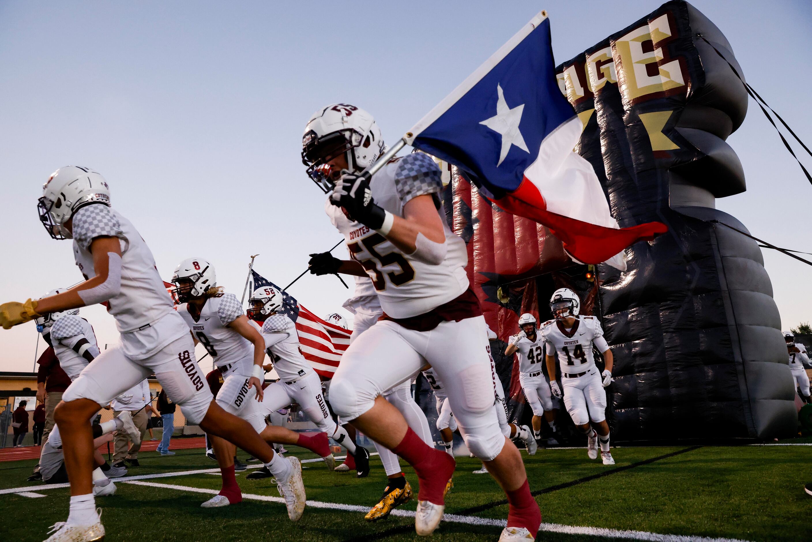 Frisco Heritage players run out before the start of a District 5-5A Division I game between...