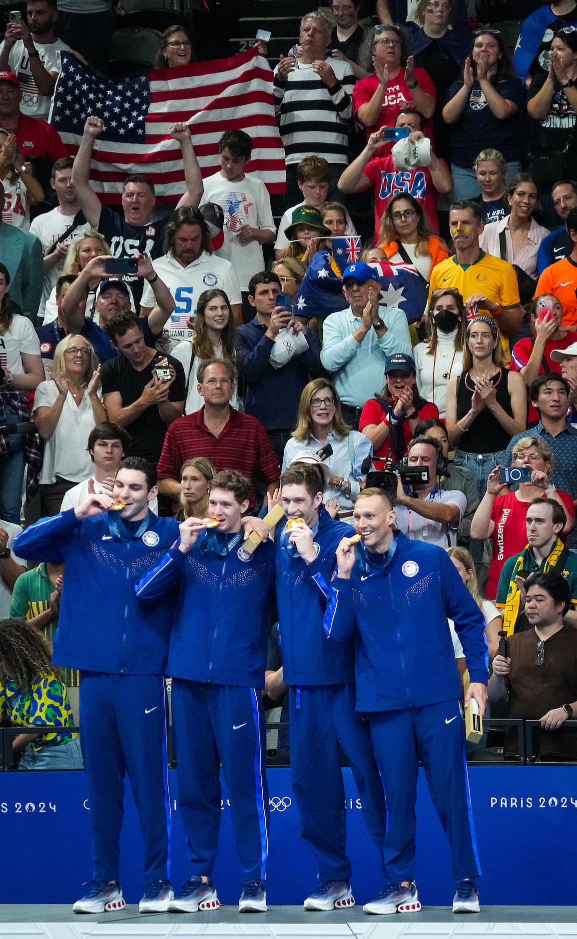 The crowd cheers members of the United States men's gold medal winning 4x100-meter freestyle...