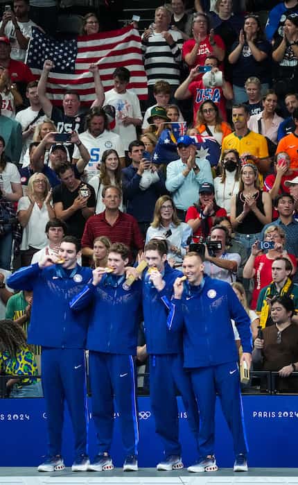 The crowd cheers members of the United States men's gold medal winning 4x100-meter freestyle...