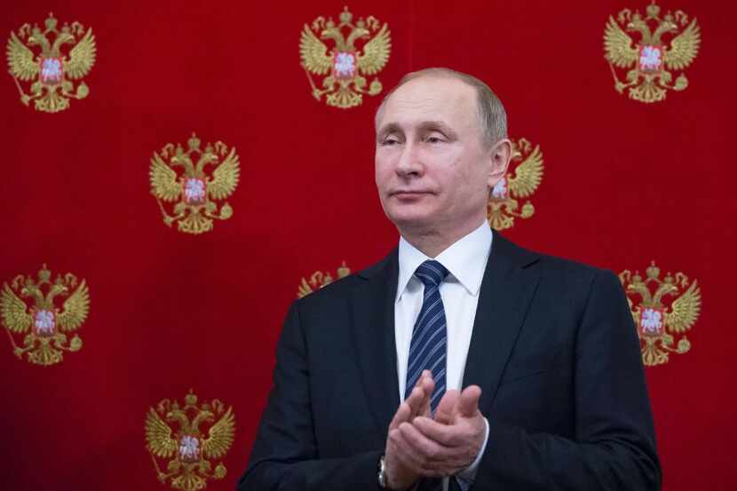 Russian President Vladimir Putin applauds during a signing ceremony on Feb. 10, 2017....