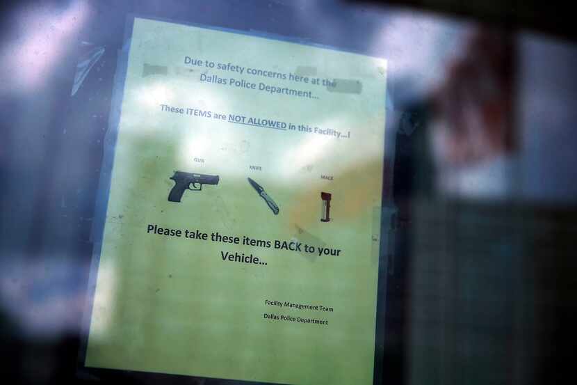 
A sign urges visitors to not enter the premises with weapons at the Dallas Police...