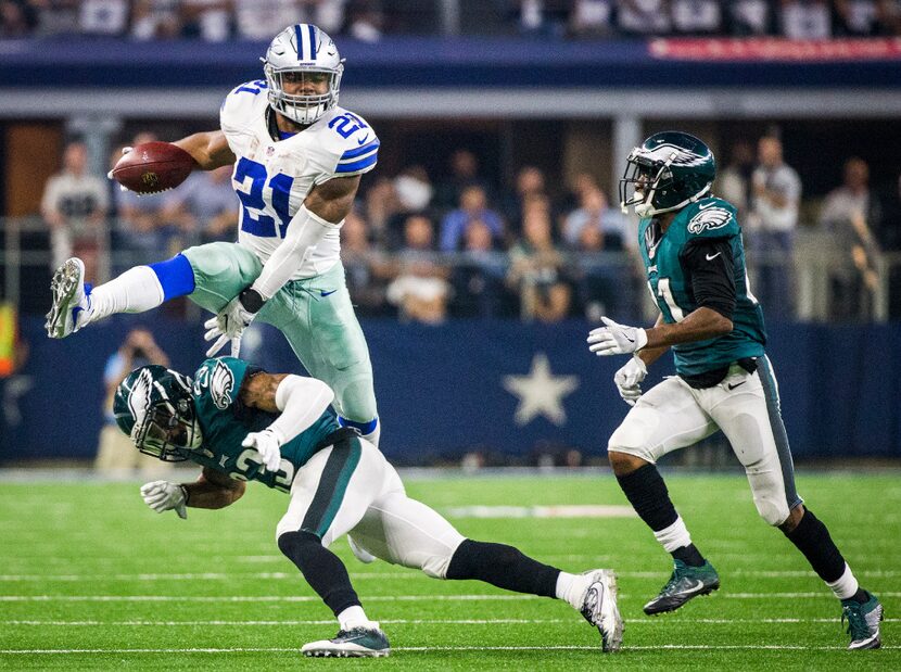 Dallas Cowboys running back Ezekiel Elliott (21) hurdles Philadelphia Eagles free safety...