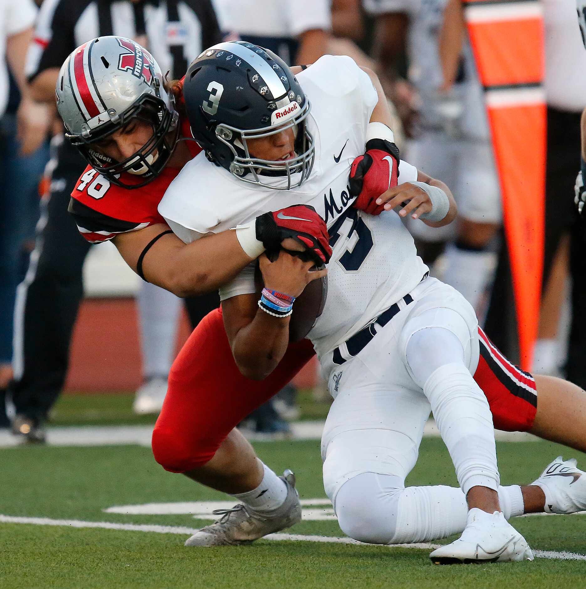 Flower Mound High School quarterback Nick Evers (3) is stopped short of the line of...