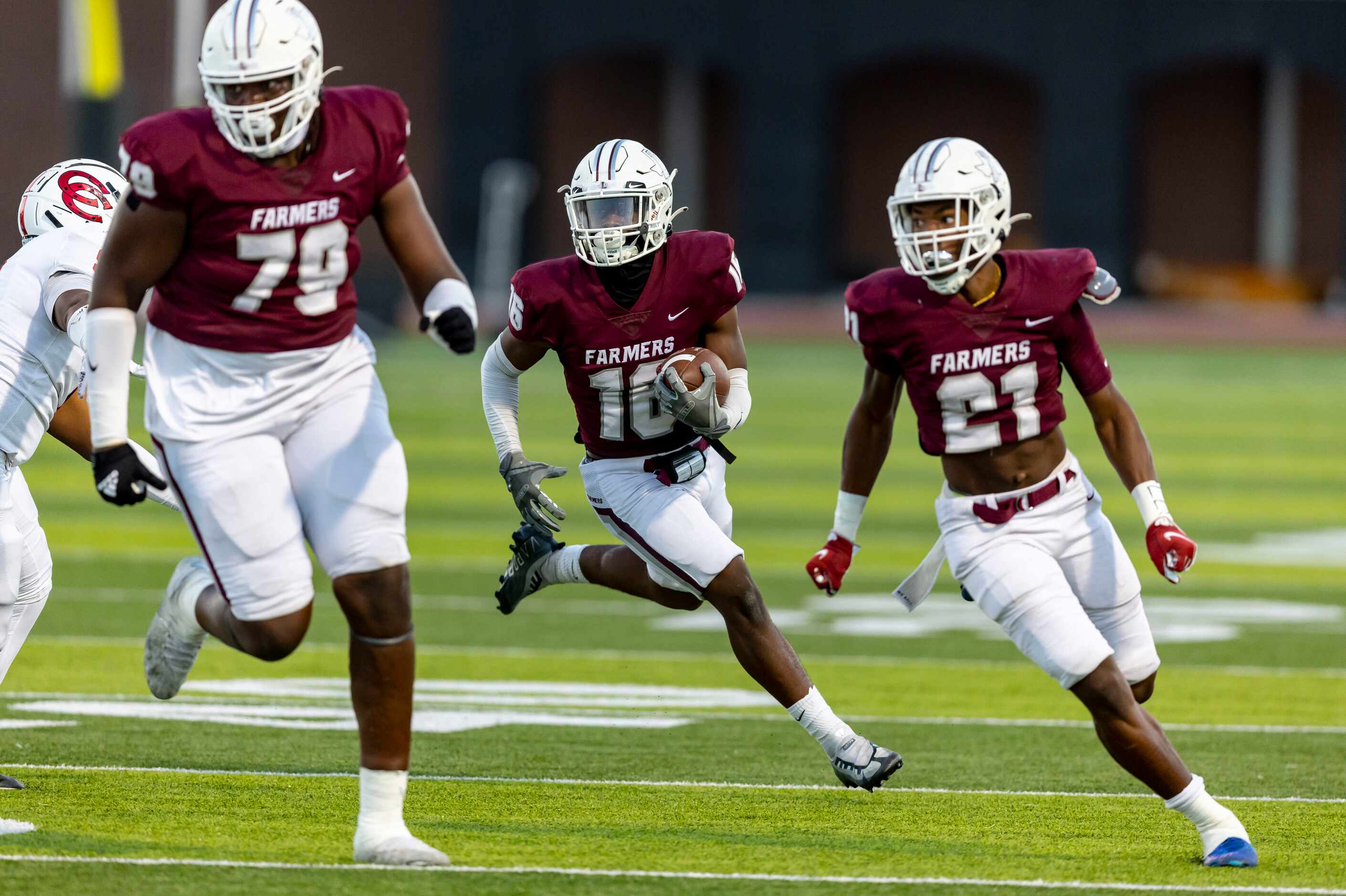 Lewisville senior running back Phillip Patterson (16) carries the ball as senior offensive...