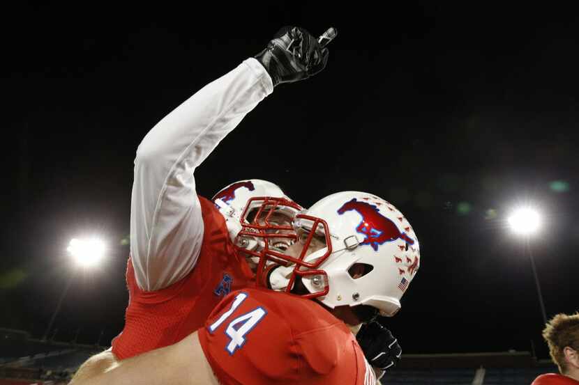 Southern Methodist Mustangs quarterback Garrett Krstich (14) holds up Southern Methodist...
