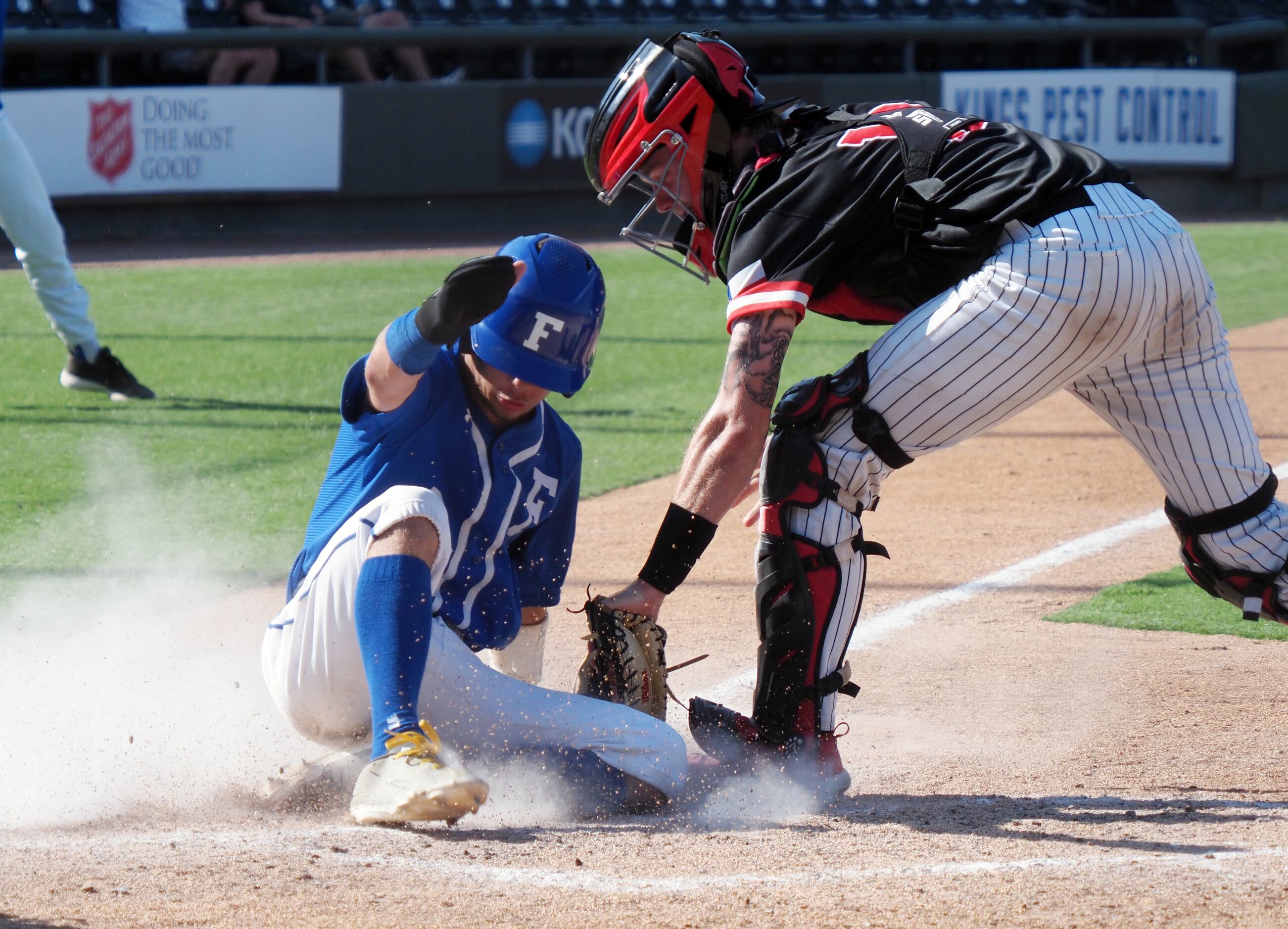 Mansfield Legacy catcher Andrew Taylor (right) is late with the tag at home against...